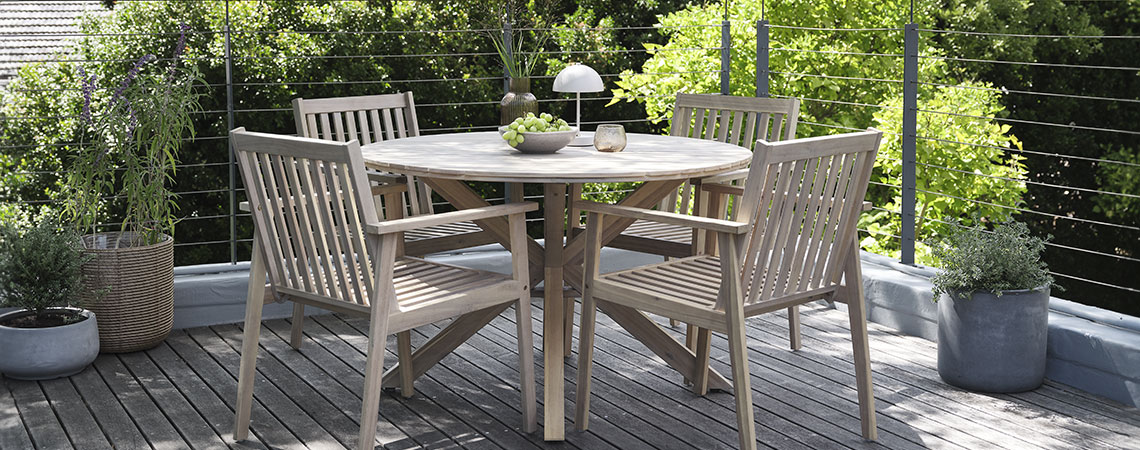 Une table de jardin ronde avec 4 chaises sur une terrasse