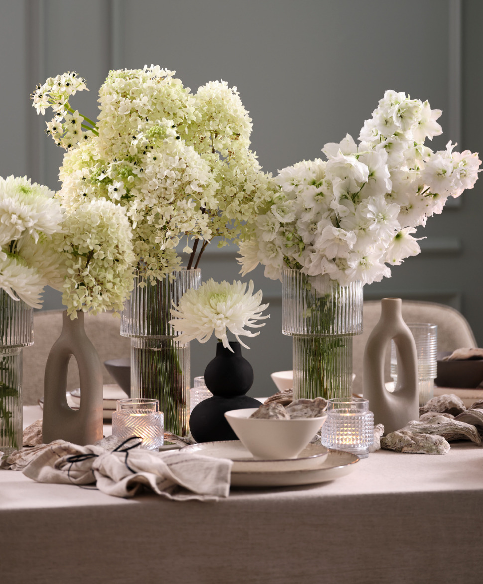 Gardez un aspect plus clair lorsque vous vous en tenez aux couleurs de la même palette Des compositions florales de différentes hauteurs peuvent créer une table accueillante