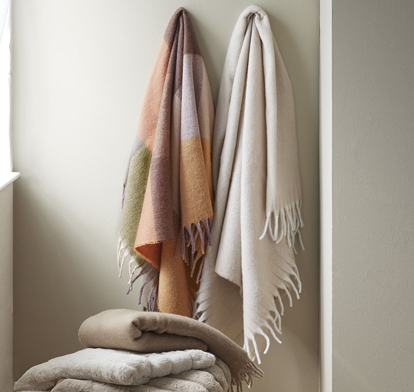 TUSENFRYD throw is available in different patterns and colours Multi-coloured and beige throws