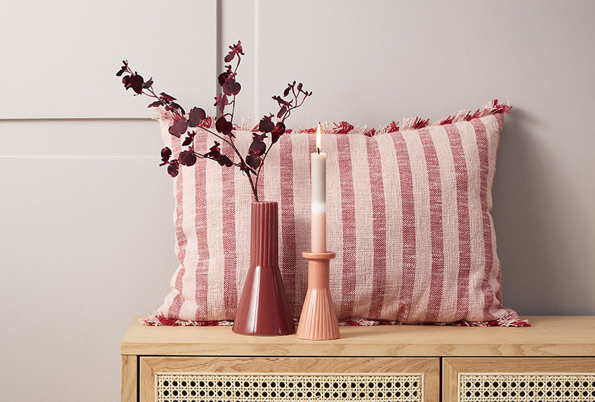 DAGFIOL cushion, EGMUND vase and THRISTAN candlestick Cushion, vase and candlestick on a sideboard